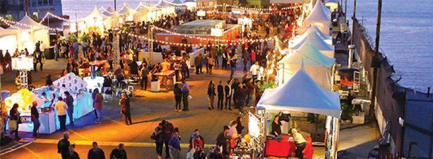 Outdoor festival with food stalls and visitors